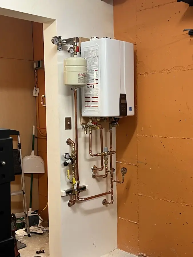 Plumbing technician inspecting water heater connections in Altamonte Springs